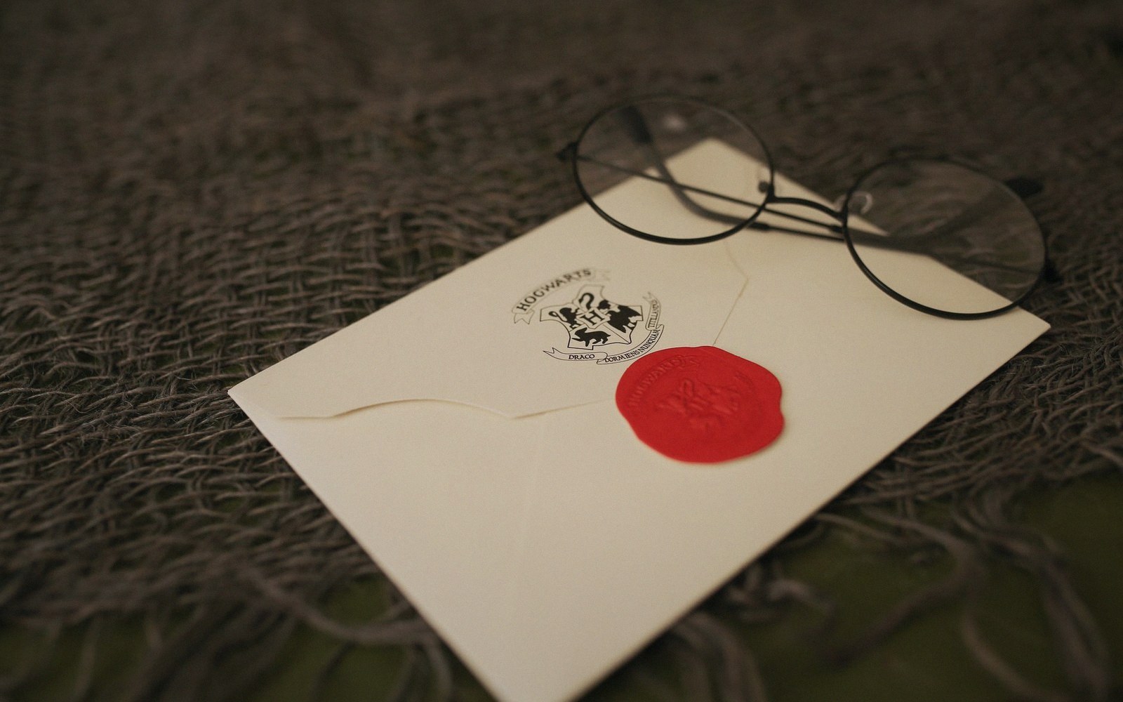 A sealed envelope with a signature across the flap